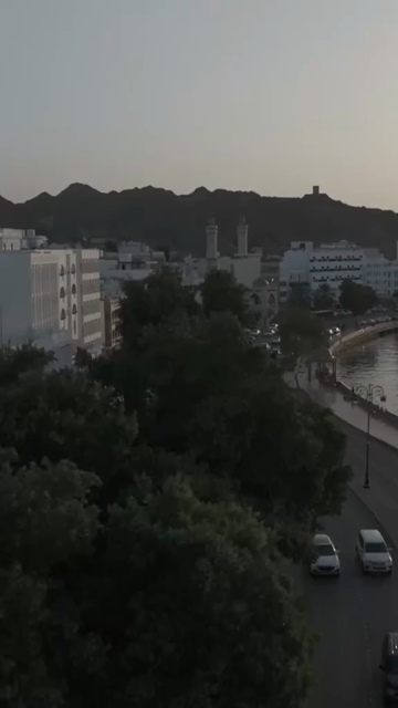 Vertical Aerial Evening View of Mutrah Corniche Muscat Oman with Hajar Mountains