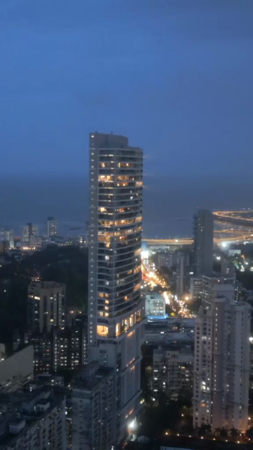 Vertical Aerial Night View of Mumbai Cityscape and Coastal Skyline