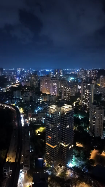 Vertical Aerial Night View of Mumbai Skyline and Illuminated Cityscape