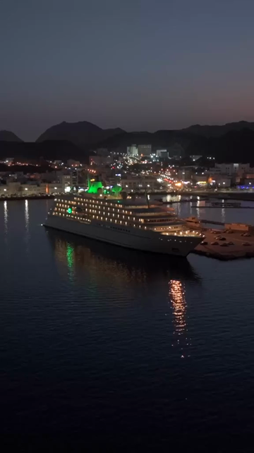 Vertical Aerial Night View of Mutrah Corniche Muscat Oman Waterfront and City Lights