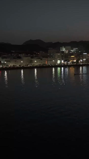 Vertical Aerial Night View of Mutrah Corniche Muscat Oman Waterfront and City Lights