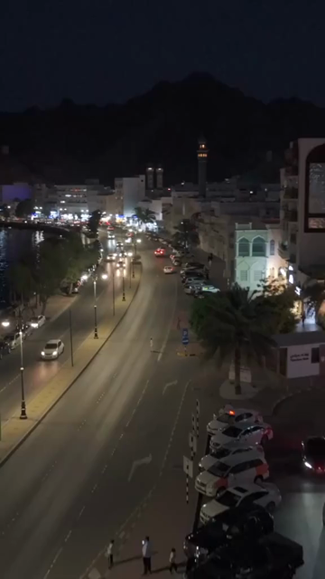 Vertical Aerial Night View of Mutrah Corniche Muscat Oman Waterfront and City Lights