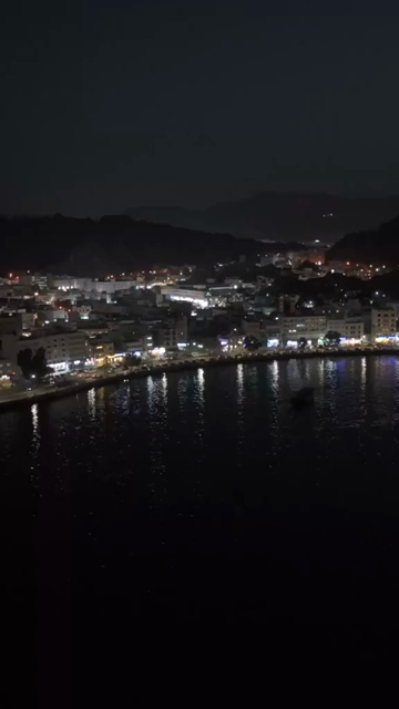 Vertical Aerial Night View of Mutrah Corniche Muscat Oman Waterfront and City Lights