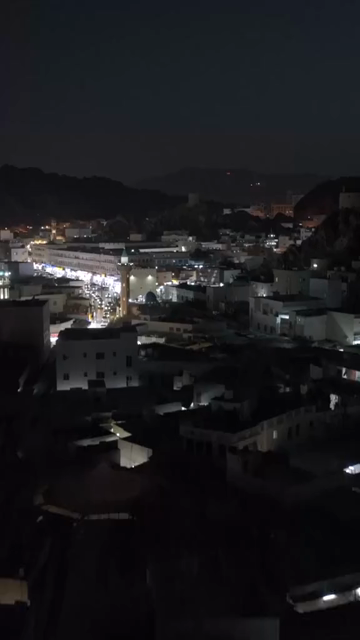 Vertical Aerial Night View of Mutrah Corniche Muscat Oman Waterfront and City Lights