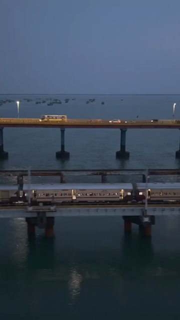 Vertical Aerial Night View of Train Crossing Pamban Bridge Tamil Nadu India
