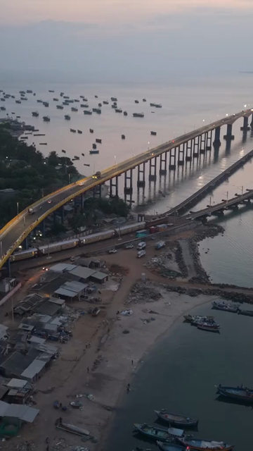 Vertical Aerial Night View of Train Crossing Pamban Bridge Tamil Nadu India