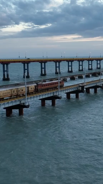 Vertical Aerial Night View of Train Crossing Pamban Bridge Tamil Nadu India