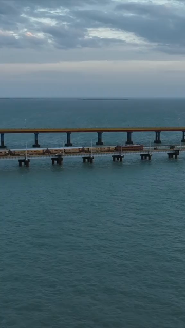 Vertical Aerial Night View of Train Crossing Pamban Bridge Tamil Nadu India