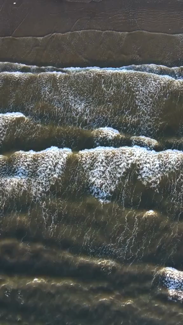 Vertical Aerial Shot of Ocean Waves at Miramar Beach Goa India