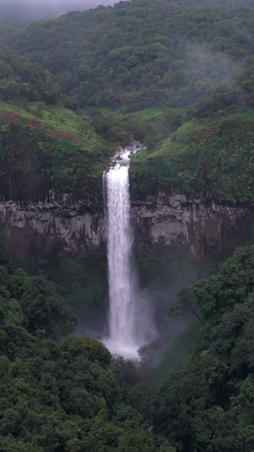 Vertical Aerial View of Barki Waterfall Amid Lush Green Forest Kolhapur Maharashtra