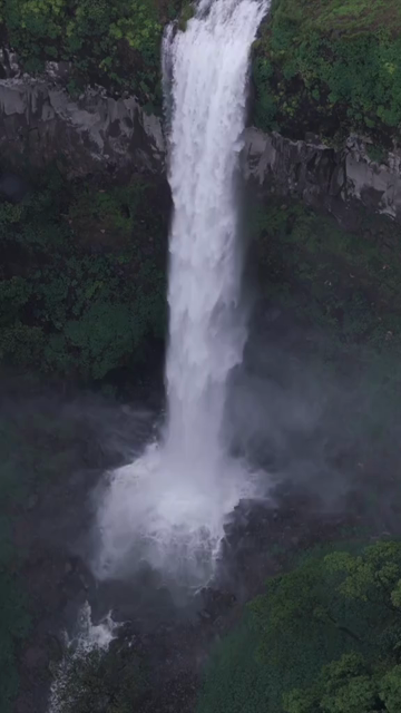 Vertical Aerial View of Barki Waterfall Amid Lush Green Forest Kolhapur Maharashtra