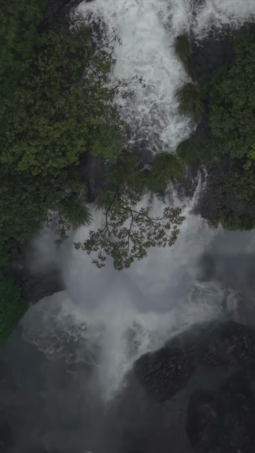 Vertical Aerial View of Barki Waterfall Amid Lush Green Forest Kolhapur Maharashtra