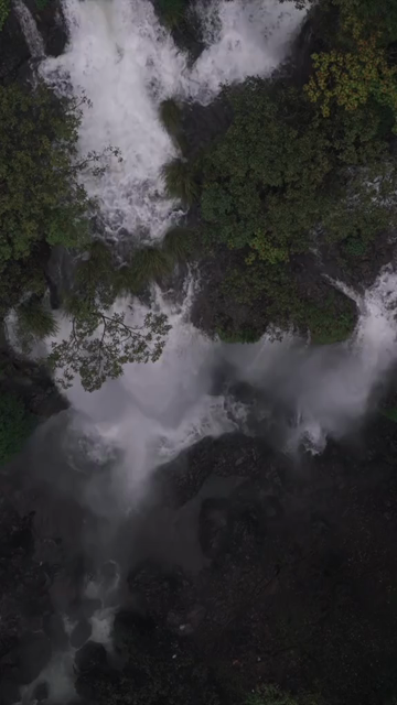 Vertical Aerial View of Barki Waterfall Amid Lush Green Forest Kolhapur Maharashtra