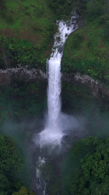 Vertical Aerial View of Barki Waterfall Amid Lush Green Forest Kolhapur Maharashtra