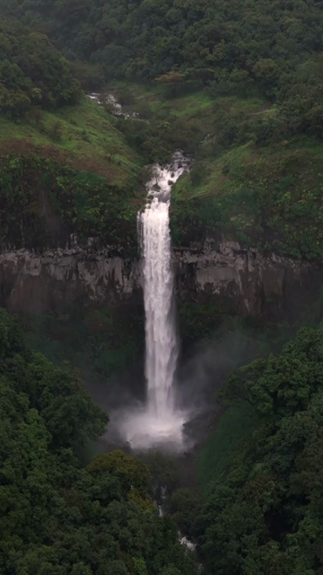 Vertical Aerial View of Barki Waterfall Amid Lush Green Forest Kolhapur Maharashtra
