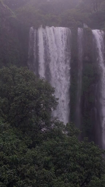 Vertical Aerial View of Barki Waterfall Amid Lush Green Forest Kolhapur Maharashtra