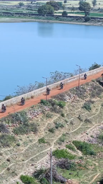 Vertical Aerial View of Bikers Riding Along Kolar Dam Reservoir Madhya Pradesh