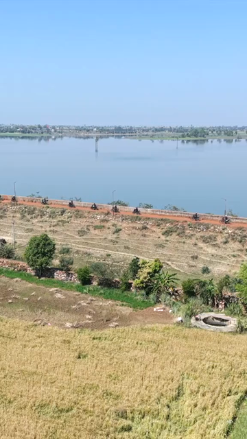 Vertical Aerial View of Bikers Riding Along Kolar Dam Reservoir Madhya Pradesh