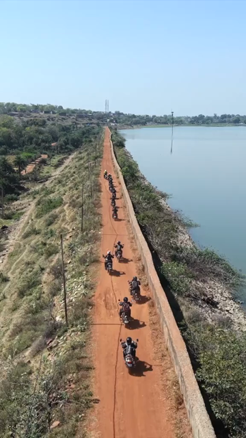 Vertical Aerial View of Bikers Riding Along Kolar Dam Reservoir Madhya Pradesh