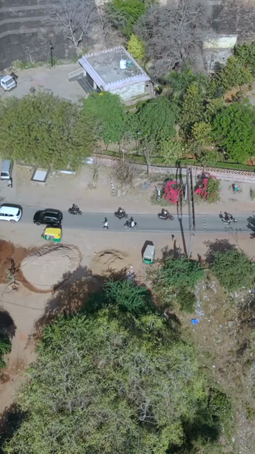 Vertical Aerial View of Bikers Riding Along Gwalior Fort Road Madhya Pradesh India