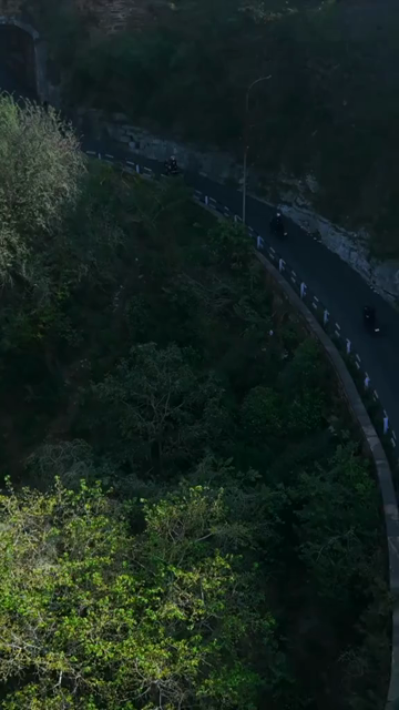 Vertical Aerial View of Bikers Riding Along Gwalior Fort Road Madhya Pradesh India