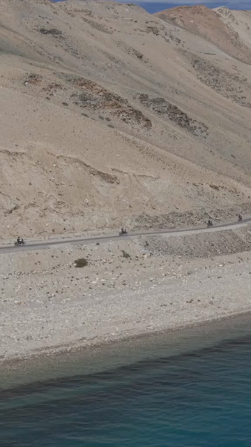 Vertical Aerial View of Tourist Bikers at Pangong Lake Ladakh India