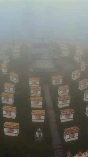 Vertical Aerial View of Mandala Top Buddhist Stupas Covered in Fog in Arunachal Pradesh India