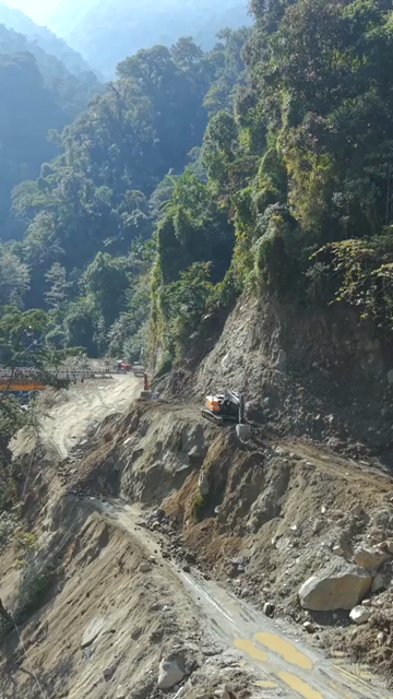 Vertical Aerial View of Mountain Road Construction and Landslide Clearing in India