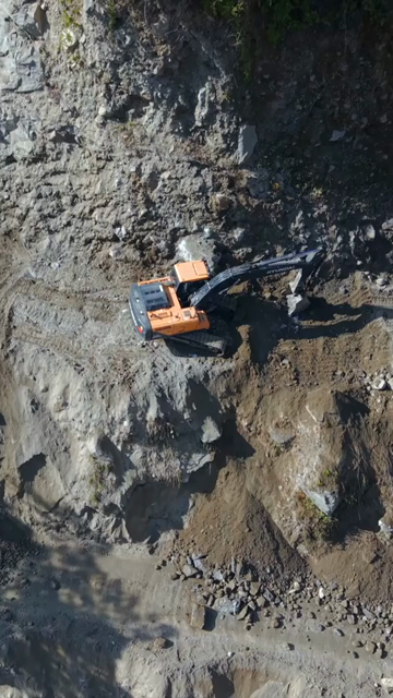 Vertical Aerial View of Mountain Road Construction and Landslide Clearing in India