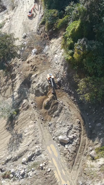 Vertical Aerial View of Mountain Road Construction and Landslide Clearing in India