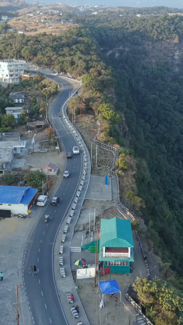 Vertical Aerial View of Cars Driving on Winding Hill Road in Arunachal Pradesh India
