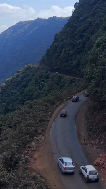 Vertical Aerial View of Cars Driving on Winding Hill Road in Arunachal Pradesh India