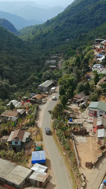Vertical Aerial View of Cars Driving on Winding Hill Road in Arunachal Pradesh India