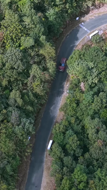 Vertical Aerial View of Cars Driving on Winding Hill Road in Arunachal Pradesh India