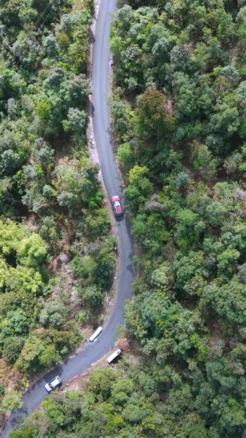 Vertical Aerial View of Cars Driving on Winding Hill Road in Arunachal Pradesh India