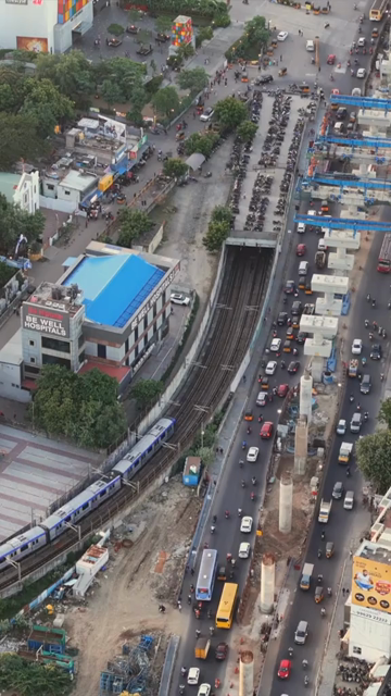 Vertical Aerial View of Chennai Metro Train Entering Underground Tunnel