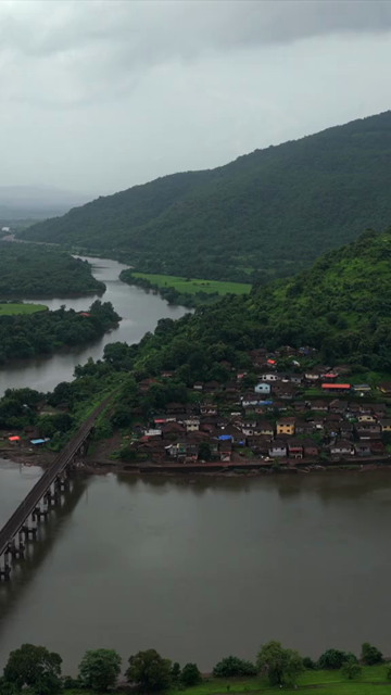 Vertical Aerial View of Dasgaon Village and Savitri River with Konkan Railway Bridge Maharashtra