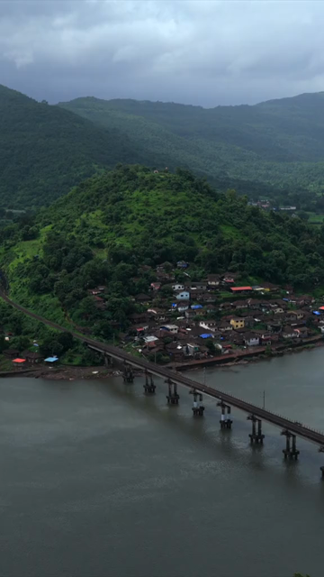 Vertical Aerial View of Dasgaon Village and Savitri River with Konkan Railway Bridge Maharashtra