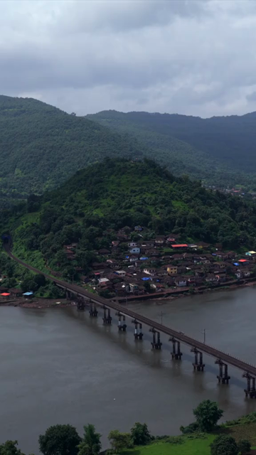 Vertical Aerial View of Dasgaon Village and Savitri River with Konkan Railway Bridge Maharashtra
