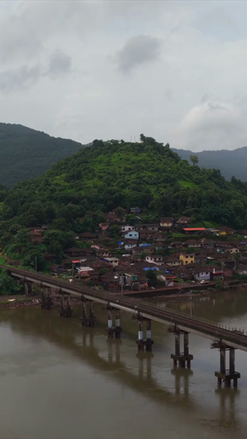 Vertical Aerial View of Dasgaon Village and Savitri River with Konkan Railway Bridge Maharashtra