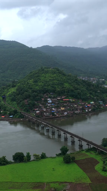 Vertical Aerial View of Dasgaon Village and Savitri River with Konkan Railway Bridge Maharashtra