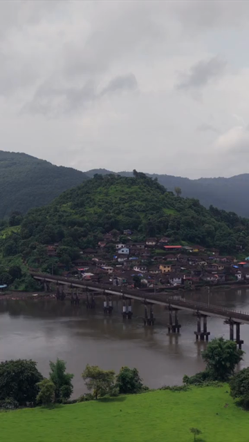 Vertical Aerial View of Dasgaon Village and Savitri River with Konkan Railway Bridge Maharashtra
