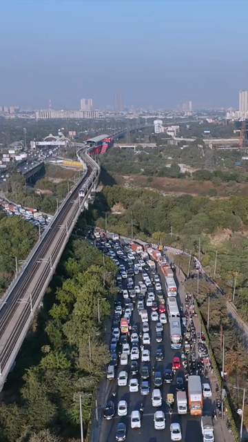 Vertical Aerial View of Delhi Metro and Traffic at Kalindi Kunj Bridge India