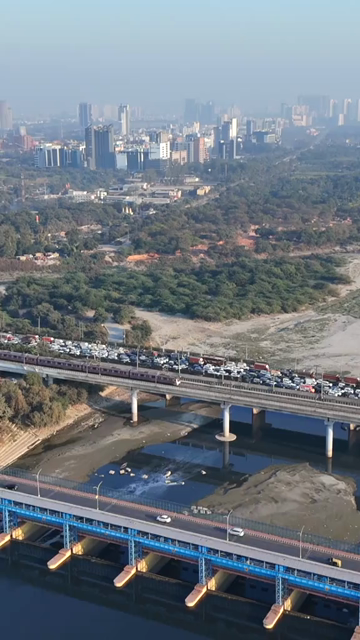 Vertical Aerial View of Delhi Metro and Traffic at Kalindi Kunj Bridge India