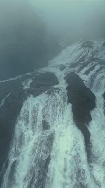 Vertical Aerial View of Dudhsagar Waterfall Surrounded by Lush Forest in Goa India