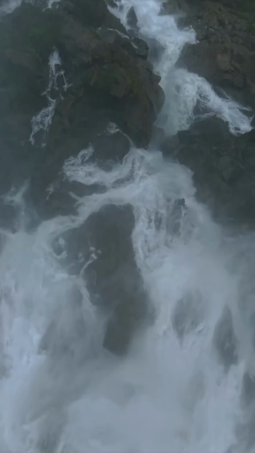 Vertical Aerial View of Dudhsagar Waterfall Surrounded by Lush Forest in Goa India