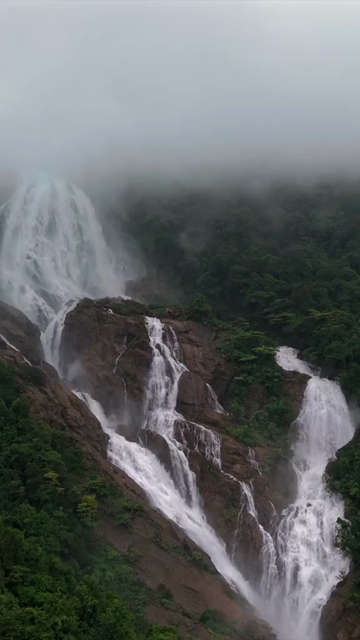 Vertical Aerial View of Dudhsagar Waterfall Surrounded by Lush Forest in Goa India