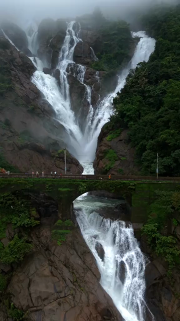 Vertical Aerial View of Dudhsagar Waterfall Surrounded by Lush Forest in Goa India