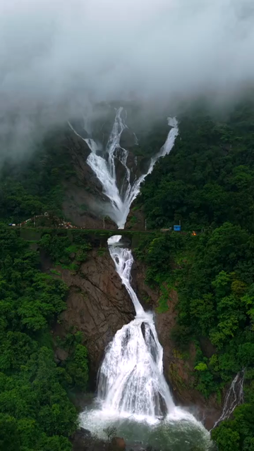 Vertical Aerial View of Dudhsagar Waterfall Surrounded by Lush Forest in Goa India