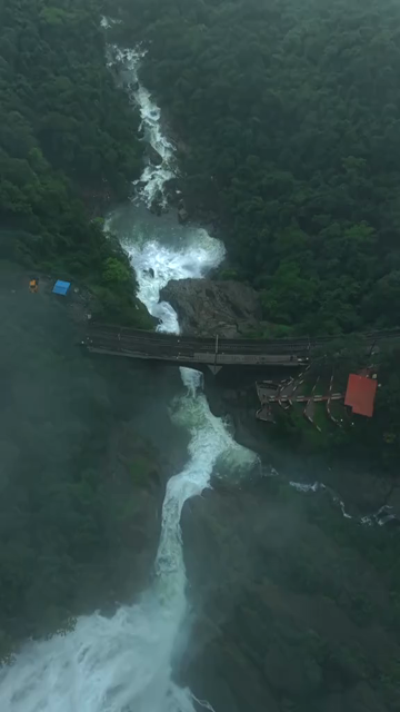 Vertical Aerial View of Dudhsagar Waterfall Surrounded by Lush Forest in Goa India